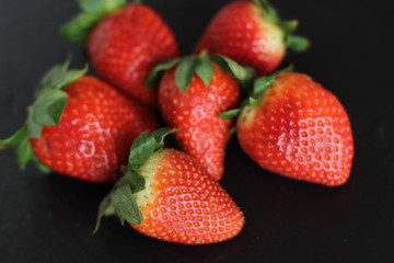fresh red tasty sweet strawberry, on black background 