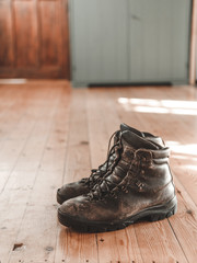 pair of boots on wooden floor 