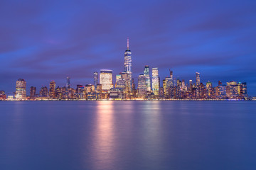 Fototapeta na wymiar Financial district from hudson river at twilight with long exposure