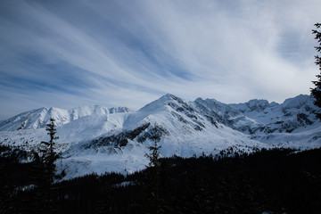 Landscape view of mountain tops in the Zakopane and in Poland area covered with fresh snow during a sunny day