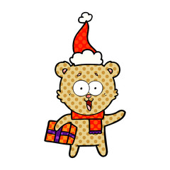 laughing teddy  bear with christmas present wearing santa hat