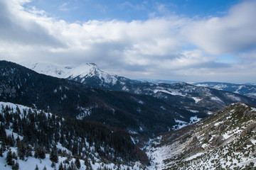 View on top of the mountains in the Zakopane area in Poland covered with fresh snow on the day with blue sky