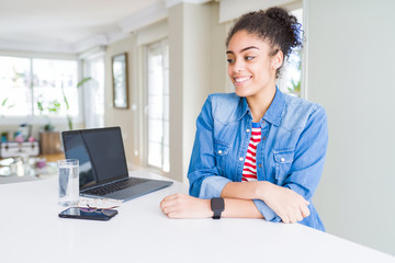 Young african american business woman working using computer laptop looking away to side with smile on face, natural expression. Laughing confident.