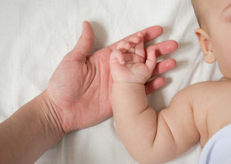 baby's hand in mom's hand