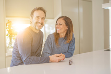 Romantic middle age couple sitting together at home