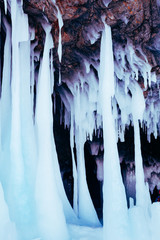 Large blocks of ice frozen waterfall or water. Icicles in the cave.