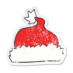retro distressed sticker of a cartoon santa hat