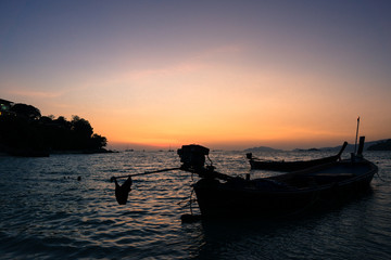 Fototapeta na wymiar silhouette of a boat at sunset, summer beach landscape