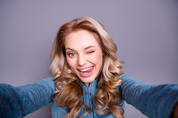 Fototapeta premium Self-portrait of her she nice cute lovely charming attractive cheerful cheery childish wavy-haired lady wearing blue shirt flirting isolated over gray violet purple pastel background