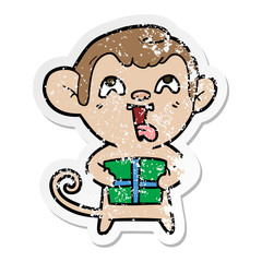 distressed sticker of a crazy cartoon monkey with christmas present