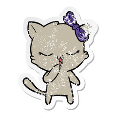 distressed sticker of a cartoon cat with bow on head