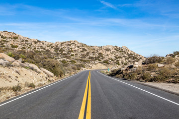 Looking along a road in Anza-Borrego Desert State Park, with a rocky landscape around