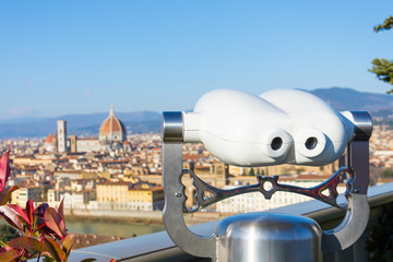 View of the city from the observation deck Piazzale Michelangelo in Florence, in the foreground binoculars