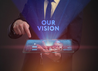 The concept of business, technology, the Internet and the network. A young entrepreneur working on a virtual screen of the future and sees the inscription: Our vision