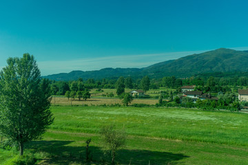Italy,La Spezia to Kasltelruth train, a large green field with trees in the background