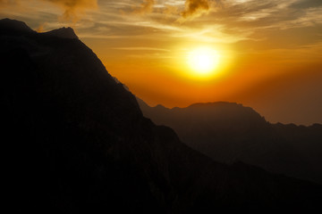 Fantastic sunset in the mountains. Jebel Rahabah. Viewpoint near Jebel Jais. Al Hajar Mountains. Ras Al Khaimah. United Arab Emirates