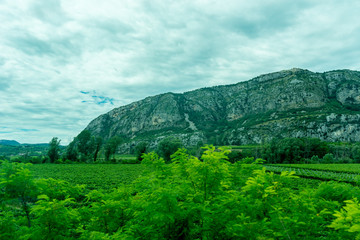 Italy,La Spezia to Kasltelruth train, a large green field with a mountain in the background
