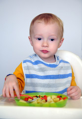 The little boy is eating his food