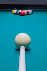 Billiard player aims to break the balls to start the game