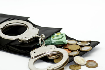 Obraz premium Kriminelle Geldgeschäfte Euro Banknoten und Handschellen