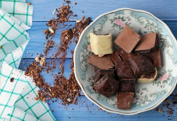 cocoa and milky chocolates on the blue floor