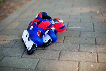 Close up photo of legs in blue inline skates standing