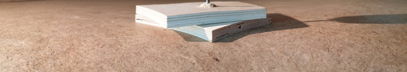 The Drilling a hole in a tree in slow motion close-up. Drilling with a metal drill.