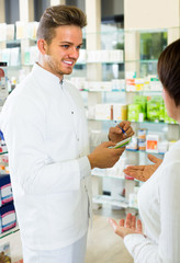 pharmacist helping customers