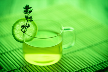 A cup of green tea with mint