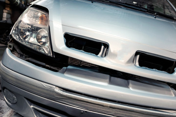 Fototapeta premium Car painted in garage. Close-up, color silver metallic.