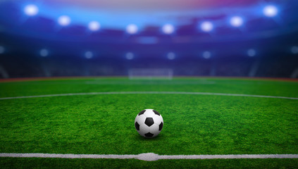 Fototapeta premium Piłka nożna na stadionie z oświetleniem