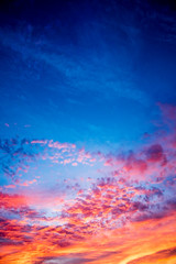A majestic and awe-inspiration combination of deep blue sky and fiery orange and yellow clouds at sunset.