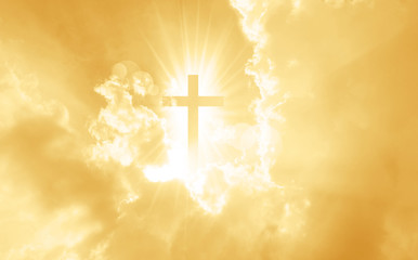 Christian cross appears bright in the yellow sky