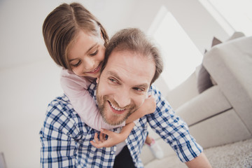 Close-up portrait of his he her she nice cute sweet lovely attractive pre-teen cheerful cheery dreamy positive girl handsome bearded dad daddy having fun holding in light white interior room