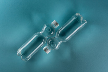 top view of plastic watter bottles on turquoise background