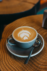 Hot art Latte Coffee in a cup on wooden table