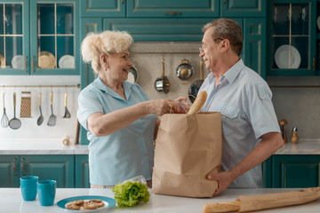 Senior couple taking groceries out