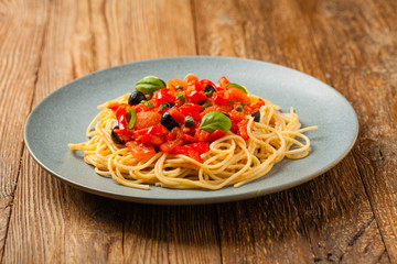 Italian spaghetti alla Pultanesca with tomatoes and olives. Served without meat and cheese.