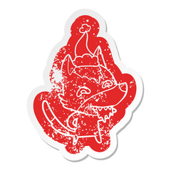 cartoon distressed sticker of a hungry wolf wearing santa hat