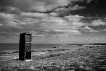 Easington, Durham / Great Britain - April 1, 2012: Former mining shaft cage turned into a memorial monument for Easington Coal Mine stands in a field overlooking the coastline.