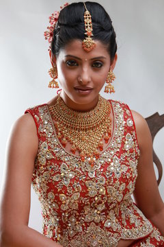 Indian bride in traditional bridal sari in studio lighting indoor