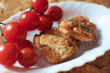 fish fried in dough and cherry tomatoes
