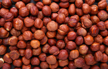 Hazelnut texture and background. Heap of peeled hazelnuts.
