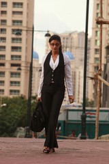 Fototapeta premium Beautiful business lady in corporate suit posing outdoor wearing spectacles outdoor - Image