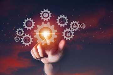 Hand of businessman holding gear icon for technology and business concept.