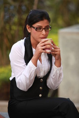 Beautiful business lady in corporate suit posing outdoor wearing spectacles outdoor - Image