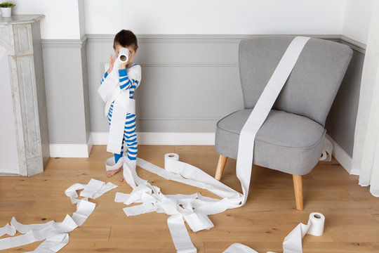 Child making mess with toilet paper rolls