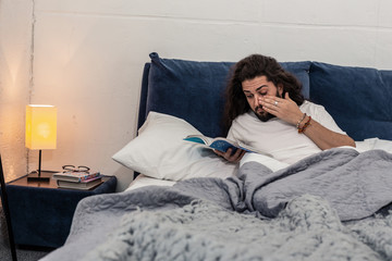 Nice sleepy man reading a science book
