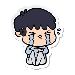 sticker of a cartoon boy crying