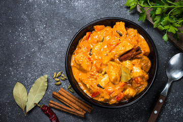 Chicken tikka masala on black top view.
